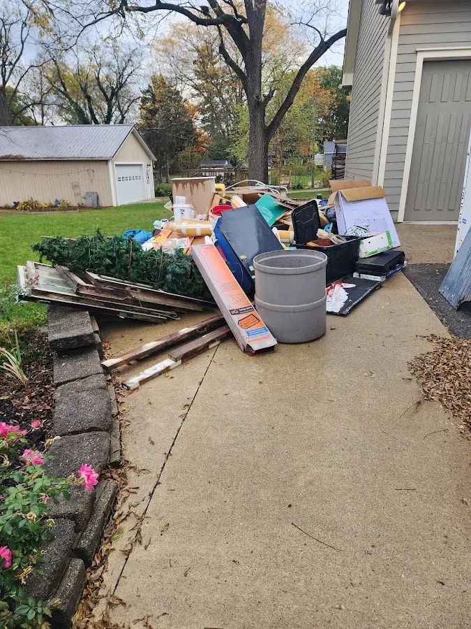 Dumpster being loaded with debris for Roofing Dumpster Rental in Mandeville